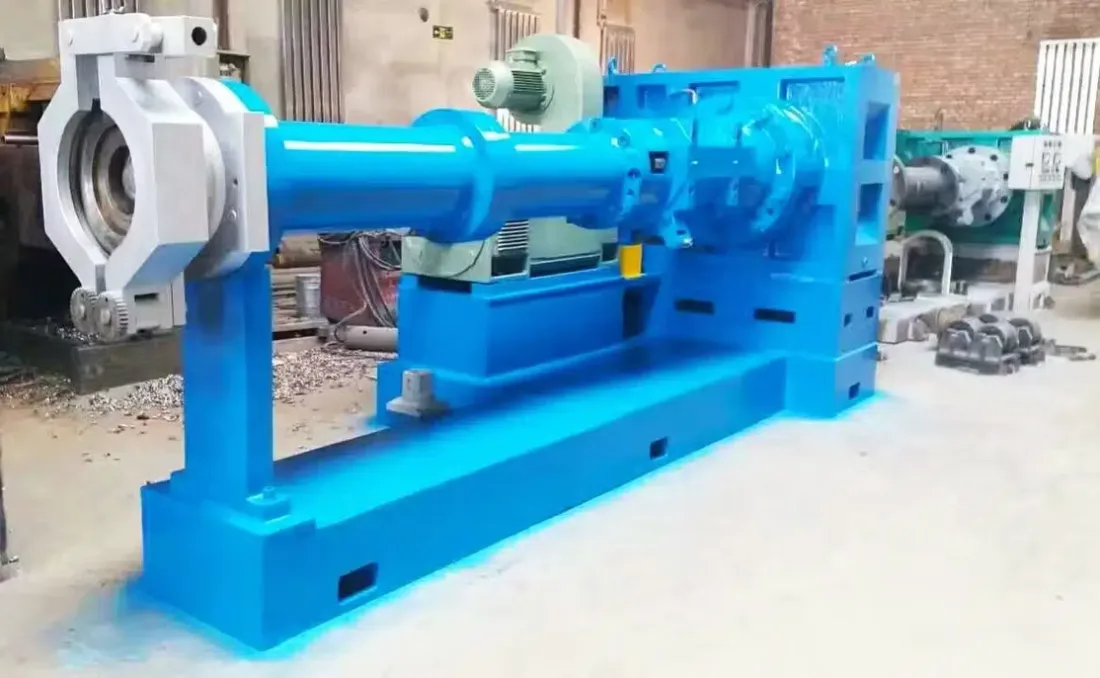 A blue rubber extruder with pin-barrel and drive motor staged in the Gear Force Machine shop.