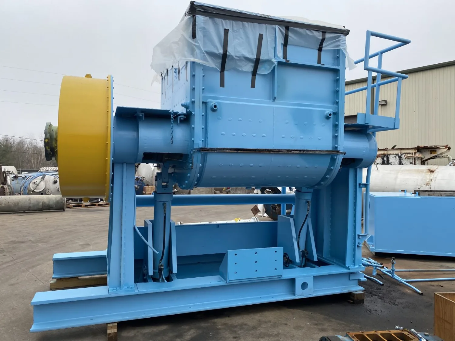 A rebuilt blue Sigma double-arm mixer staged in the yard at the Gear Force Machine shop.
